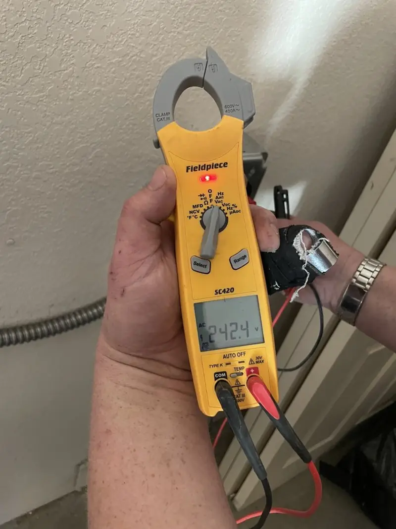 Voltage testing with clamp meter during Outlet Installation in Cleveland Heights